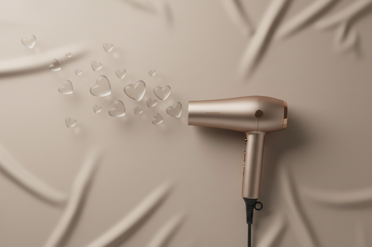 Minimal studio flat lay of a modern hair dryer placed on a soft neutral background. Small sculptural heart shapes blown out of hair dryer. Matte finish hair tool in champagne tone. Soft diffused lighting with gentle shadows. Clean, uncluttered composition. No text, no branding, no cartoon styling. Contemporary Valentine’s-inspired aesthetic.